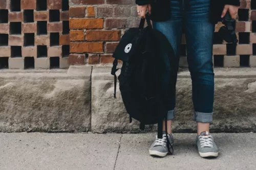 Teenager Standing Near A Brick Wall