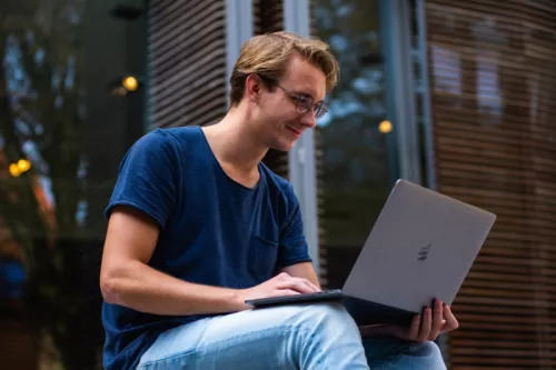 Student sitting with laptop