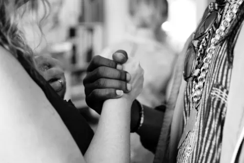 Black and white holding hands