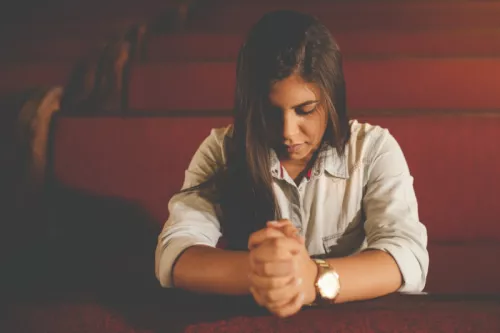Lady praying alone in church