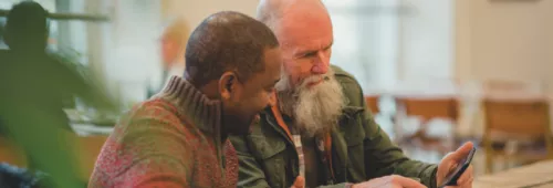 Two men looking at phone