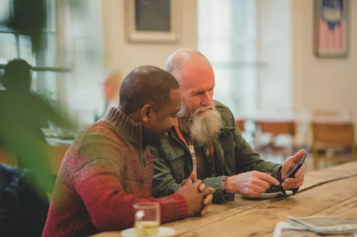 Two men looking at phone