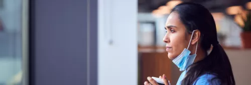 Nurse gazing through a window