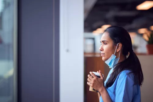 Nurse gazing through a window