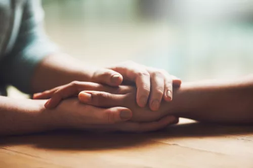 Hands comforting each other - NI consultation article