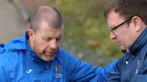 Chaplain praying with a mnager