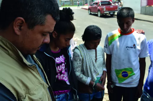 Street mentor praying for young people