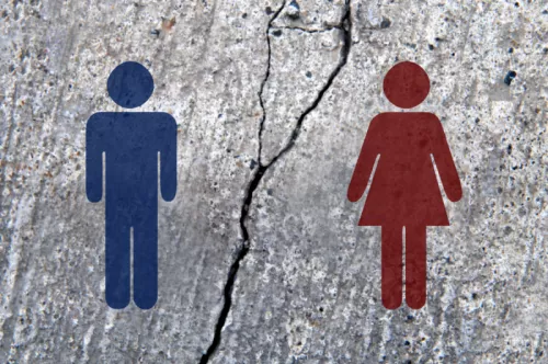 Male and female pictograms on broken asphalt, broken human relationship images stock photo