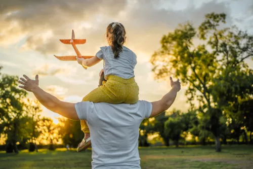 Dad and daughter in filed with plane
