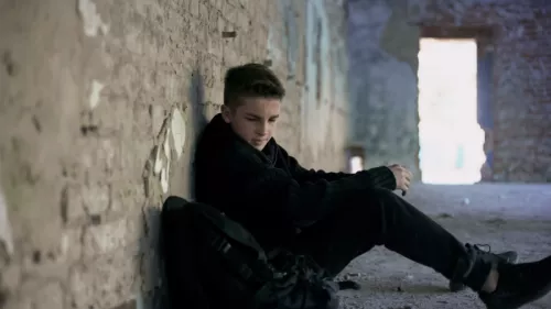 Teenage boy alone in building