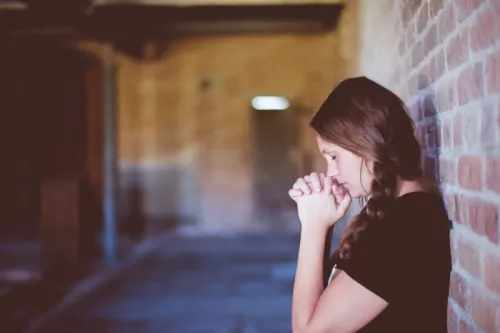 Woman praying in chapel